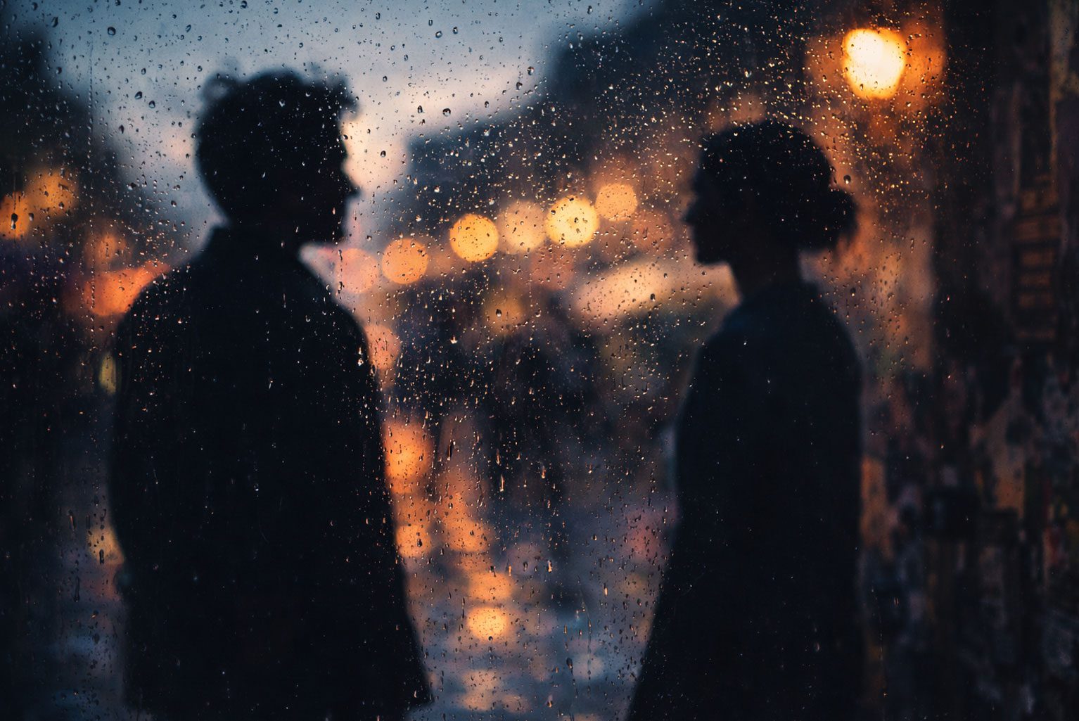 Two distant silhouettes behind rain-covered glass representing an unconventional love story at Edinburgh Fringe 2026