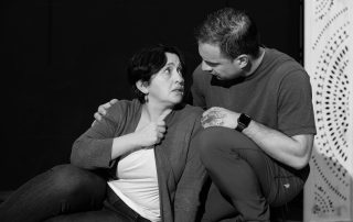 Close-up of two actors in Constellations rehearsal, holding eye contact in a pivotal emotional scene before Edinburgh Fringe run