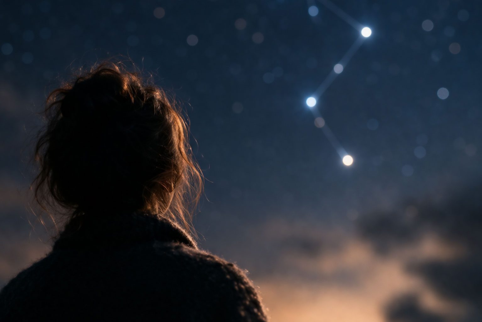Silhouetted figure looking at star constellation representing choice and multiple possibilities in Constellations play