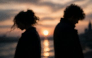 Abstract blurred silhouettes facing each other symbolizing love and timing in Constellations play