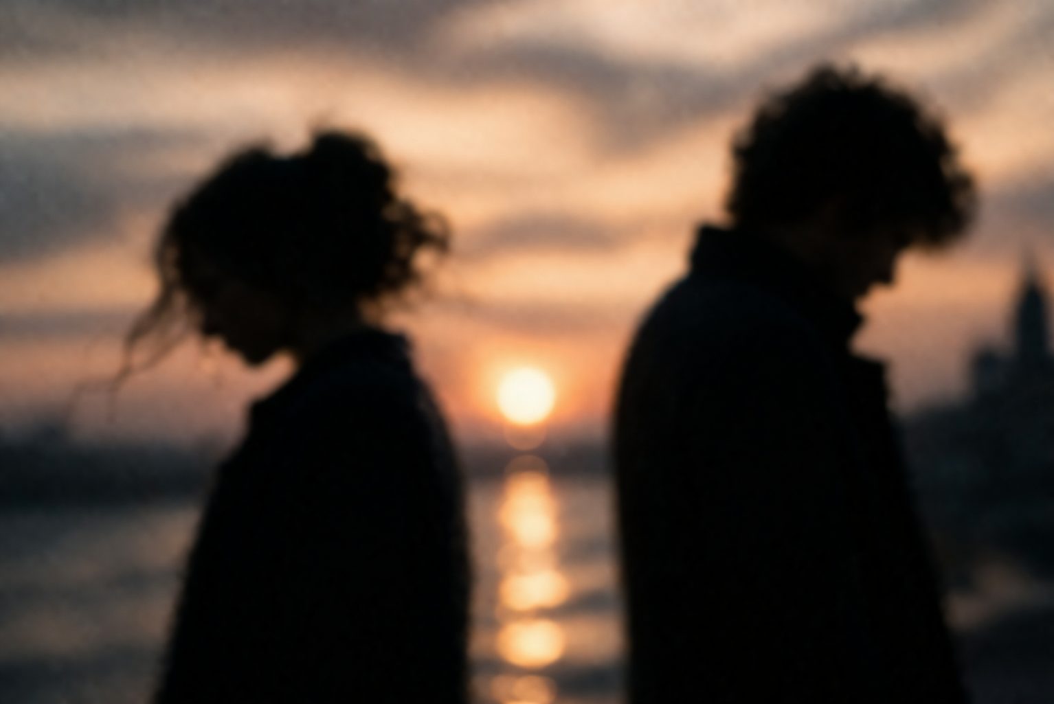 Abstract blurred silhouettes facing each other symbolizing love and timing in Constellations play